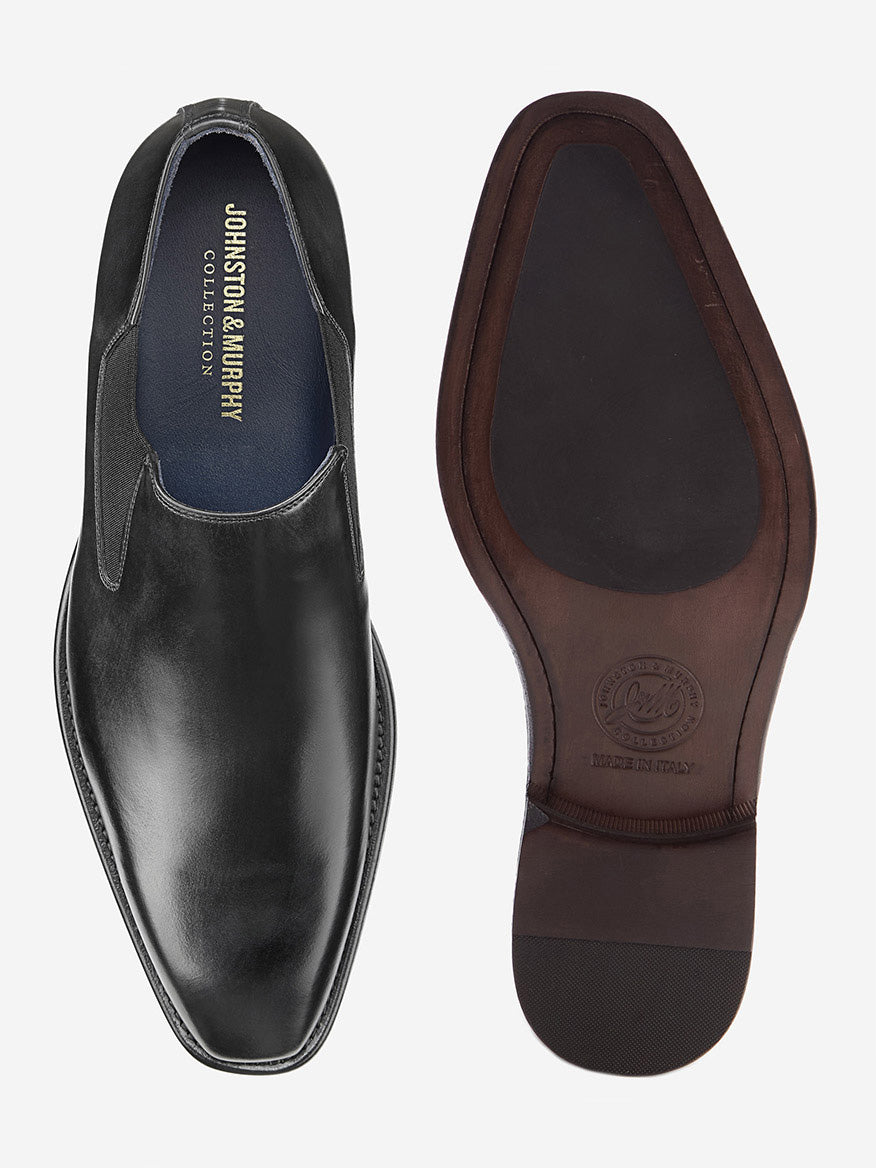 The J & M Collection Larson Slip-On features top and bottom views of a black Italian calfskin shoe with exquisite craftsmanship, a sleek design, smooth finish, brown sole with visible stitching, and a sole stamped with the brand logo.