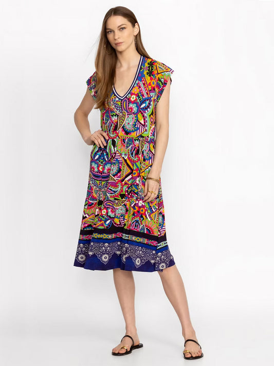 A woman in a Johnny Was Janie Favorite Tiered Tea Length Dress in Demarne Print with short sleeves and sandals, posing against a plain white background.