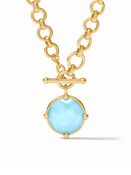 A Julie Vos Honeybee Demi Necklace in Iridescent Capri Blue with a toggle clasp and a large, round, rose cut pale blue gemstone pendant.