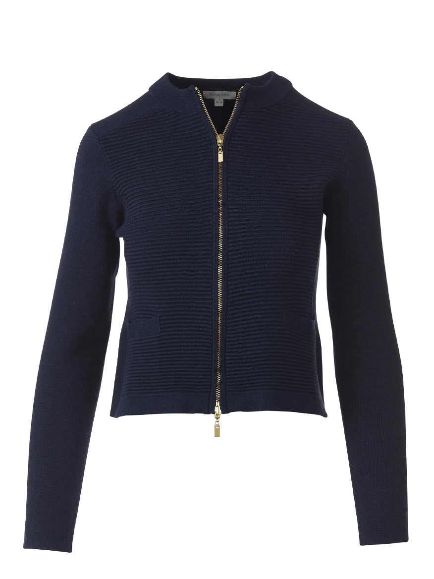 The Kinross Fitted Zip Cardigan in Navy is crafted from SuperSoft Cotton with long sleeves, a gold zipper, two front pockets, and a round neckline—ideal for upgrading your women’s knitwear collection. Shown on a white background.
