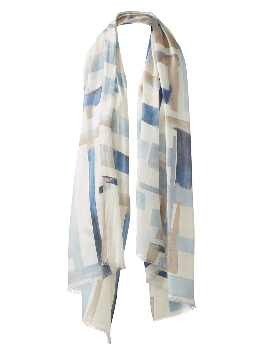 The Kinross Geo Print Scarf in Skyway Multi is a lightweight scarf with a blue, beige, and white geometric pattern and raw edges.