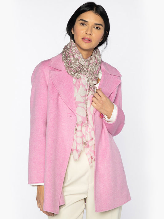 Woman posing in a pink coat with a Kinross Dancing Petals Print Scarf in Bloom Multi and cream trousers.