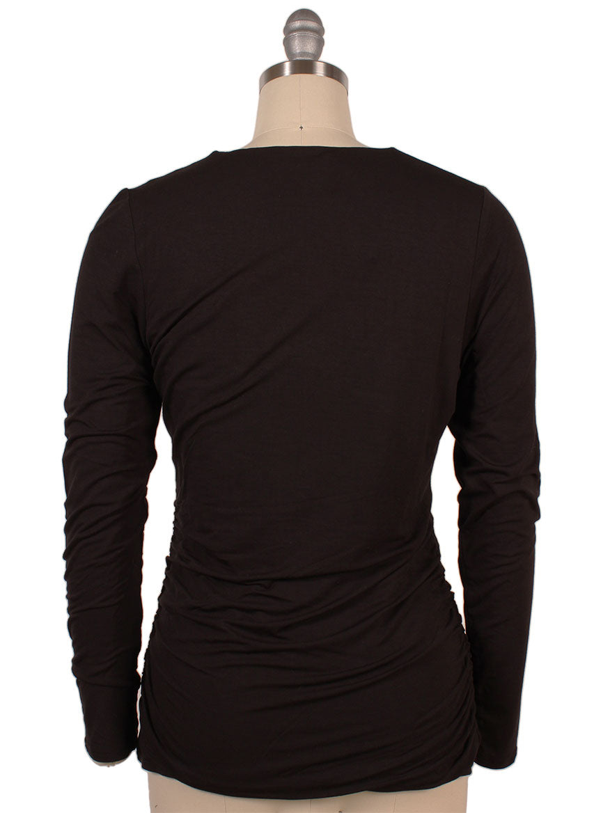 Back view of a mannequin wearing the Kinross Ruched Long Sleeve Vee in Black.