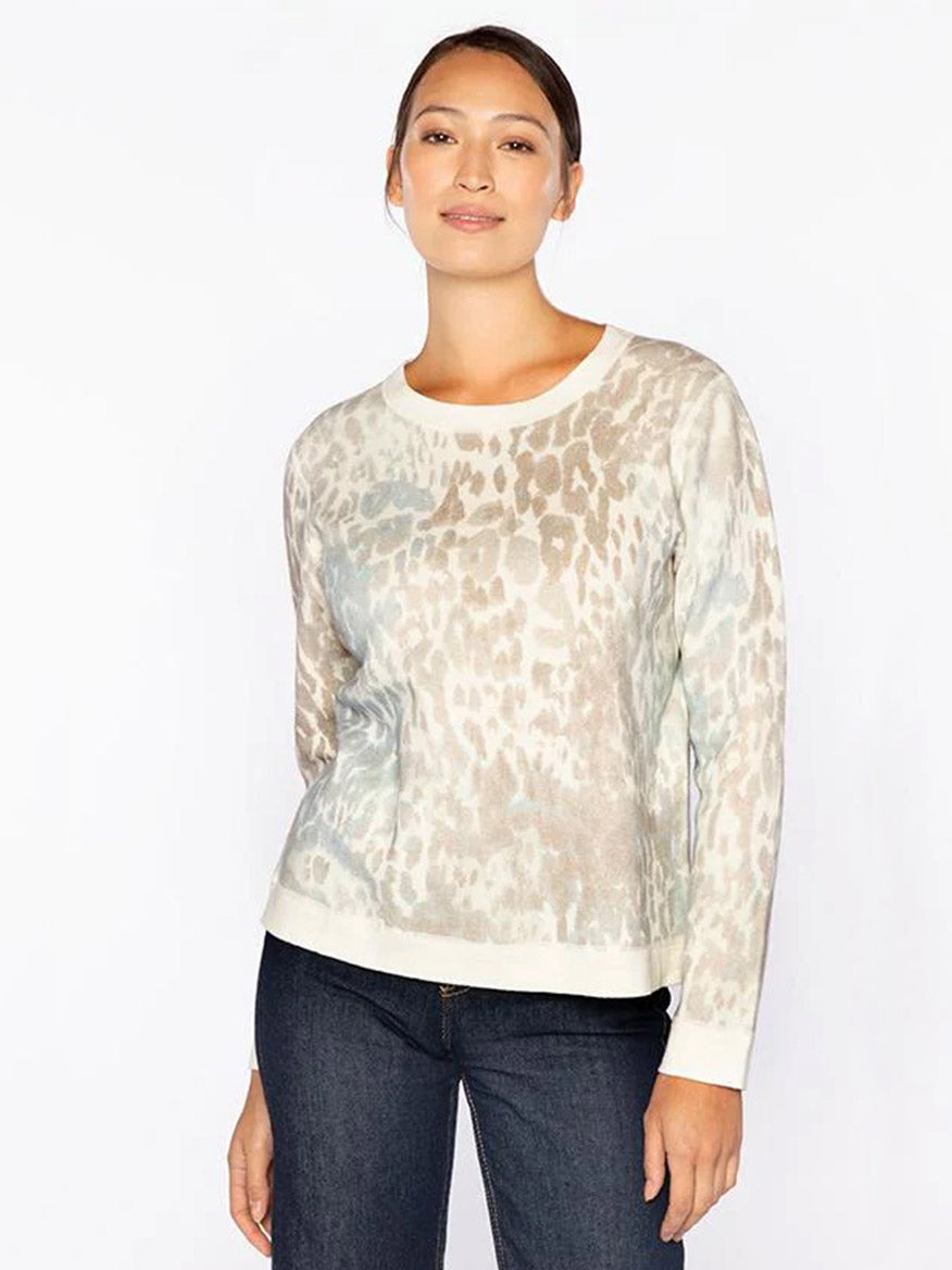 A woman wears the Kinross Leopard Print Sweatshirt in Multi with dark jeans, standing against a plain white background.