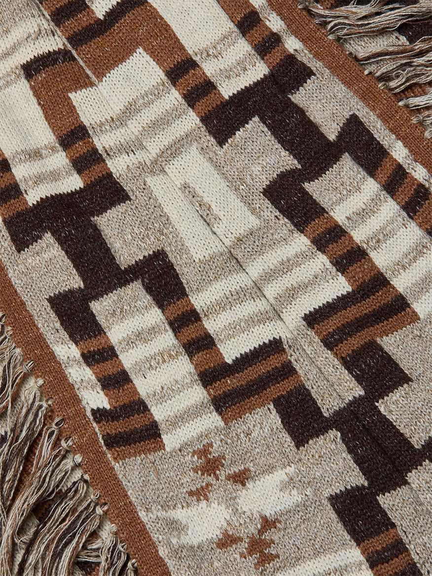 Close-up of the L'Agence Jair Cardigan in Natural Multi, showcasing a cotton jacquard fabric with geometric brown, beige, and cream star-like motifs and fringe edges.
