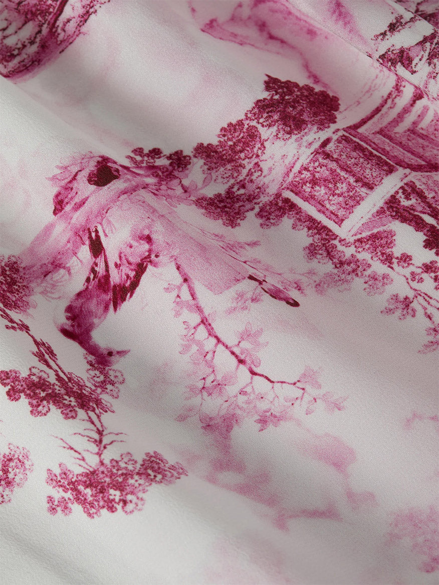 Close-up of the L'Agence Jane Silk Camisole in White/Pink Small Porcelain Toile, featuring a pink toile print with birds, tree branches, and architectural details on a white background. Perfect for a relaxed fit.