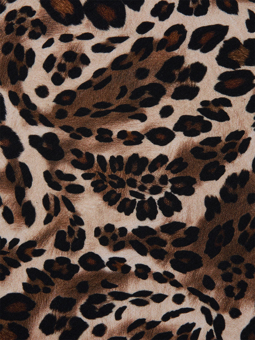 Close-up of the L'Agence Ressi Fitted Tee in Cinnamon Swirl Paisley Leopard, showcasing black and dark brown spots on a light tan background—ideal for a chic short sleeve look.