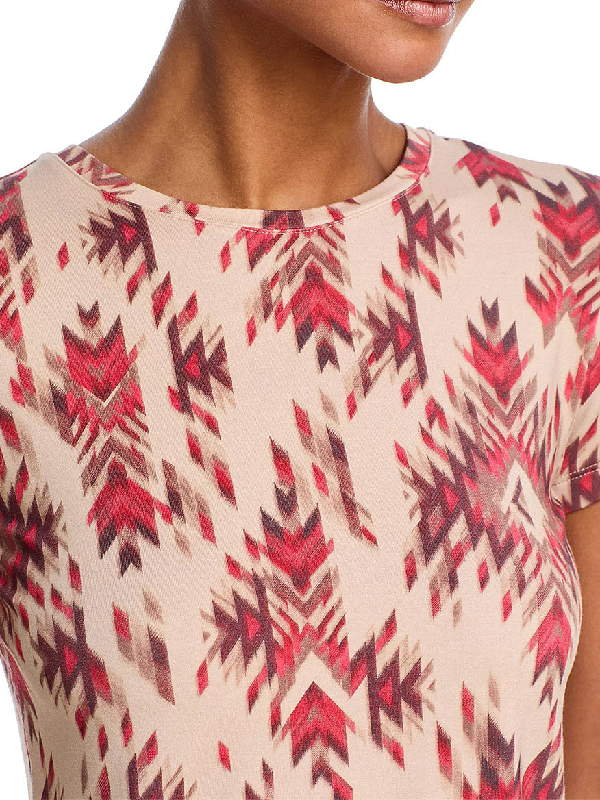 Wearing the L'Agence Ressi Fitted Tee in Tan Multi Ganado Print, only the lower half of the face, neck, and upper torso are visible.