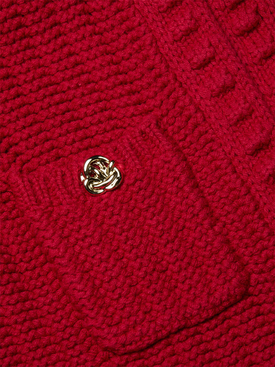 Close-up of the L'Agence Delli Cropped Cardigan in Engine Red/Gold, featuring a red textured knit, small pocket, gold button, and intricate pattern.