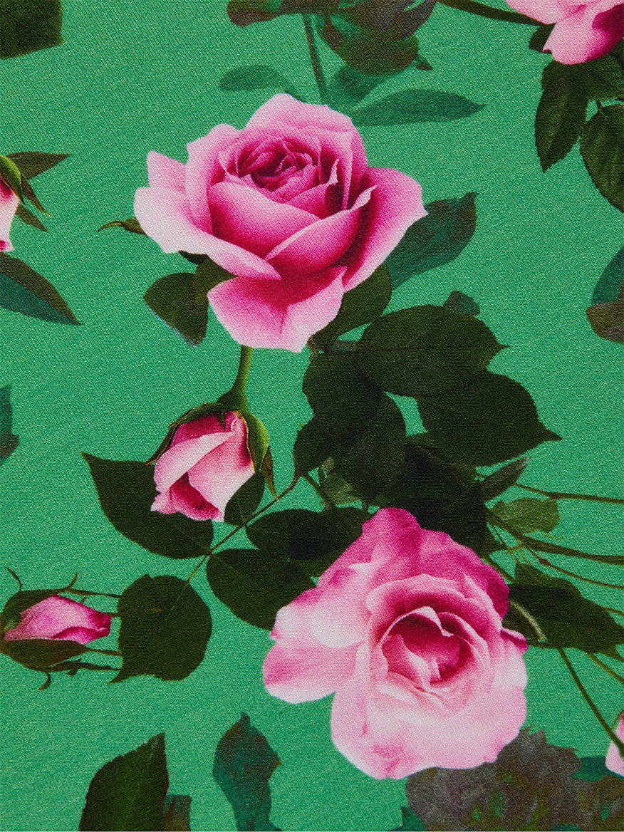 The L'Agence Ressi Fitted Tee in Green Multi Santa Fe Rose features pink roses and green leaves on a green background. This slim cut tee is made in Los Angeles for trusted quality and delivers a flattering, stylish look.