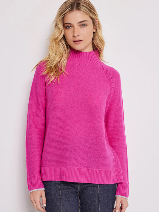A woman wearing a Rhubarb Lisa Todd Soft Supply Mock Neck Sweater and blue jeans.