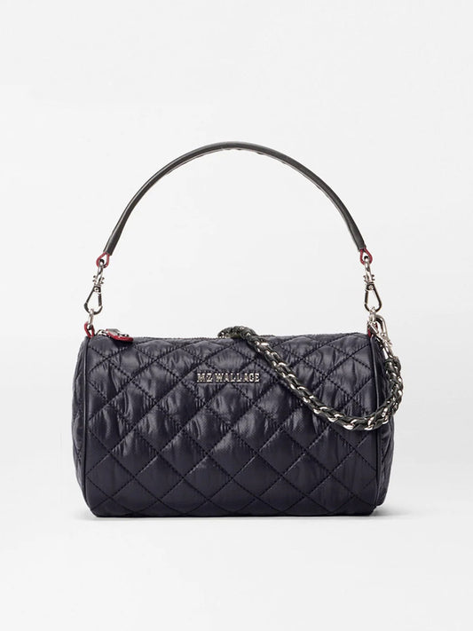 The MZ Wallace Crosby Barrel Crossbody in Black Oxford features a quilted design, short top handle, detachable chain strap, and signature hardware, shown against a plain white background.