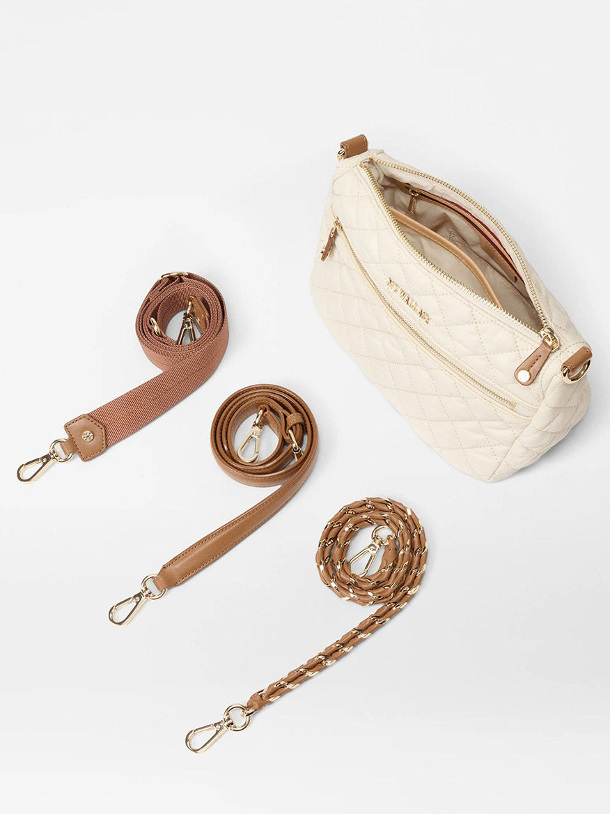 The MZ Wallace Crosby Ella Crossbody in Sandshell Oxford With Brown features a cream quilted-nylon design with gold zippers, Italian leather trim, and three interchangeable straps: pink fabric, brown leather, and brown leather with gold chain links.
