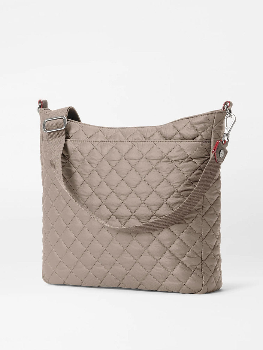 The MZ Wallace Crosby Hobo in Morning Dove Oxford is a taupe quilted shoulder bag with Italian leather accents, silver hardware, a wide strap, and a rectangular shape, shown on a plain white background.