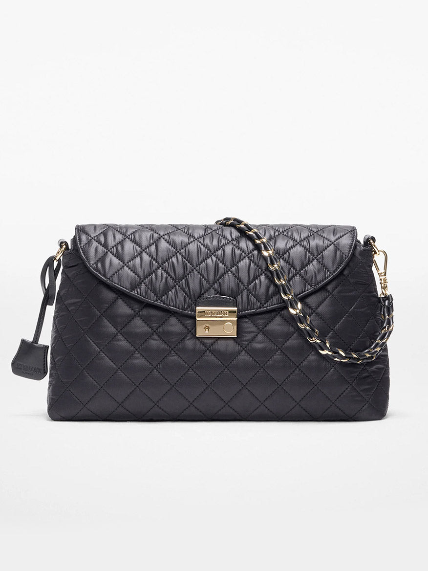 The MZ Wallace Crosby Lock Shoulder in Black Oxford features quilted black leather, a gold turn-lock clasp, chain and Italian leather strap, and a small leather tag, shown on a white background.