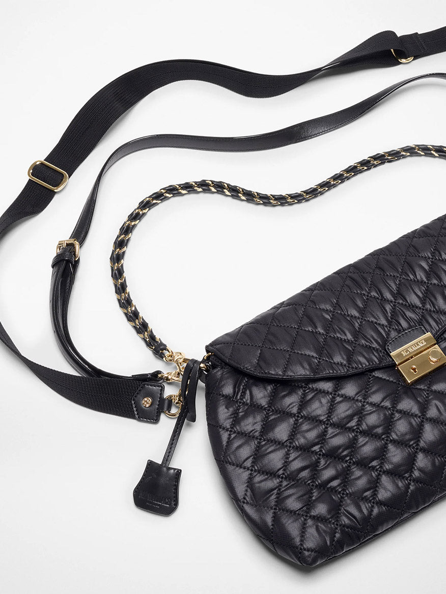The MZ Wallace Crosby Lock Shoulder in Black Oxford features a quilted leather design, gold clasp, black adjustable Italian leather strap, and a black-and-gold chain handle, shown against a white background.