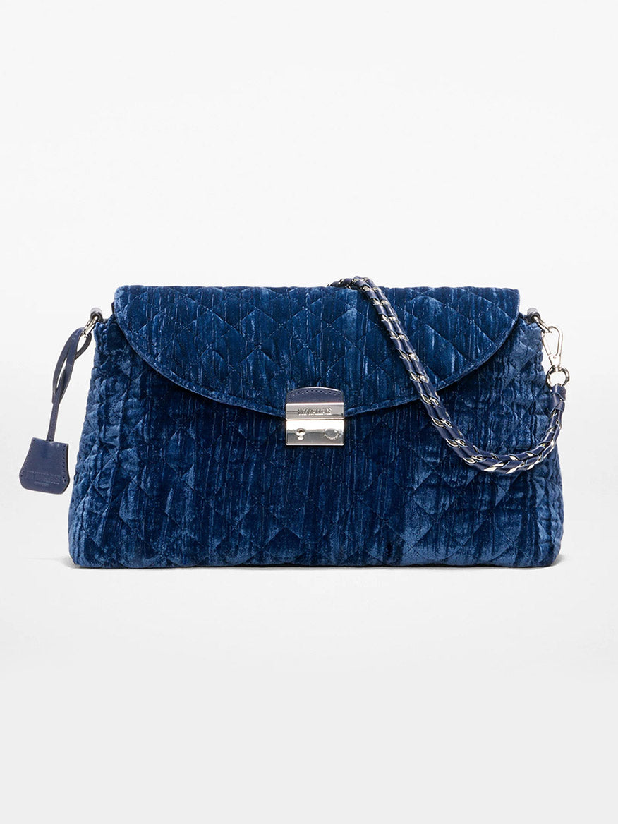 The MZ Wallace Crosby Lock Shoulder in Midnight Velvet is a blue quilted velvet handbag with a silver flap closure and detachable chain strap, shown against a plain white background.