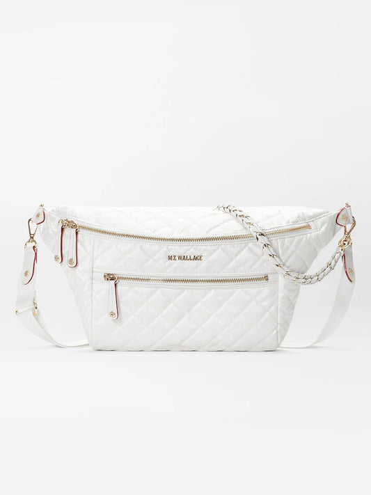 White quilted MZ Wallace Crosby Crossbody Sling Bag in Pearl Metallic Oxford with multiple zippers and a chain strap, displayed against a plain background.