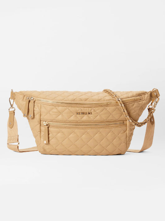 Beige quilted waist bag with multiple zippers and an adjustable strap, offering a hands-free option as a MZ Wallace Crosby Crossbody Sling Bag in Camel Oxford.