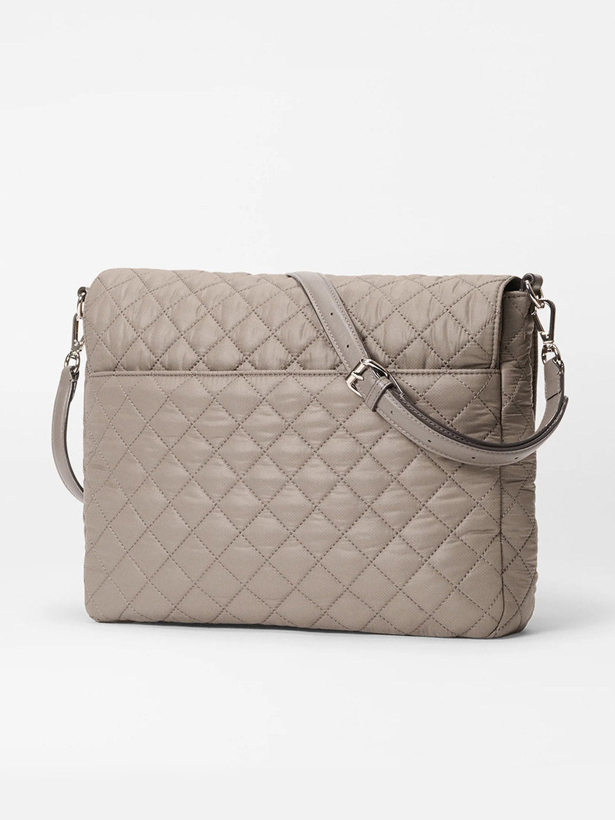 The MZ Wallace Crosby Lock Large Crossbody in Morning Dove Oxford is a quilted designer bag with an adjustable strap and front pocket, displayed against a plain white background.