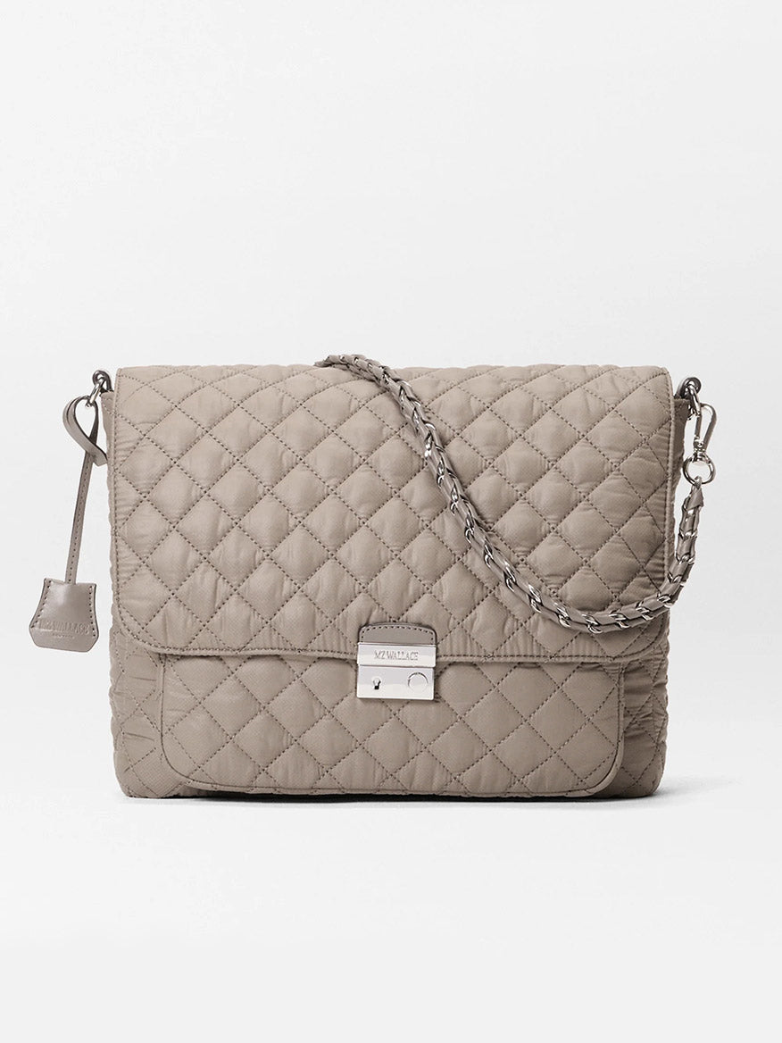 The MZ Wallace Crosby Lock Large Crossbody in Morning Dove Oxford is a taupe nylon quilted bag with a flap closure, chain and leather strap, and a front metal clasp—designer-inspired and versatile for any occasion.