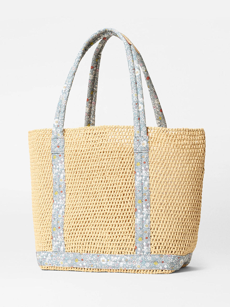 The MZ Wallace Medium Crochet Tote features two handles and June's Meadow Liberty Fabric trim, showcased against a plain light background.