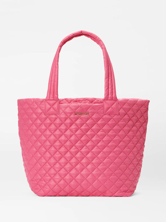A pink quilted MZ Wallace Medium Metro Tote Deluxe in Zinnia Oxford with two handles and a visible logo, displayed against a white background.