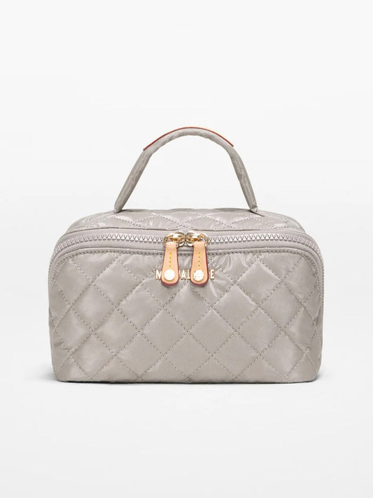 The MZ Wallace Metro Accordion Cosmetic II in Sable Pearl Metallic Oxford features a quilted light gray design, top handle, two gold zippers, and Italian leather elegance, shown on a plain white background.