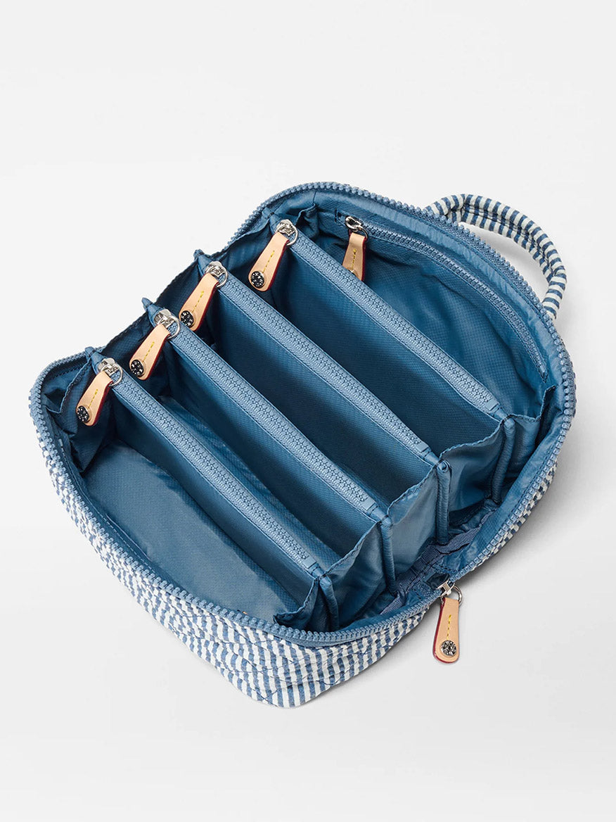 The MZ Wallace Metro Accordion Cosmetic in Seersucker Oxford features blue and white stripes, five divided compartments, and zipper pulls—ideal for organized travel essentials.