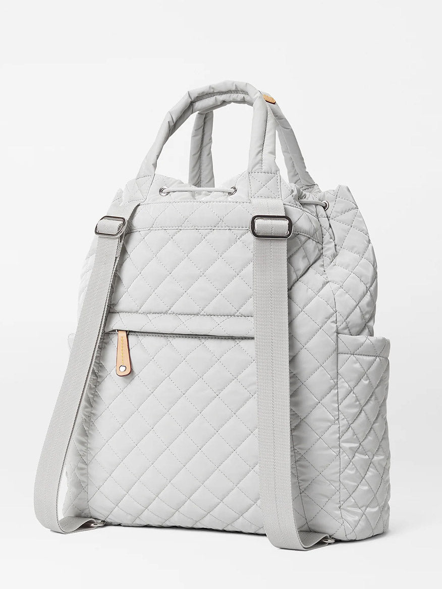 A MZ Wallace Metro Convertible Backpack in Pebble Liquid Oxford with adjustable straps, a laptop compartment, and a top handle against a white background.