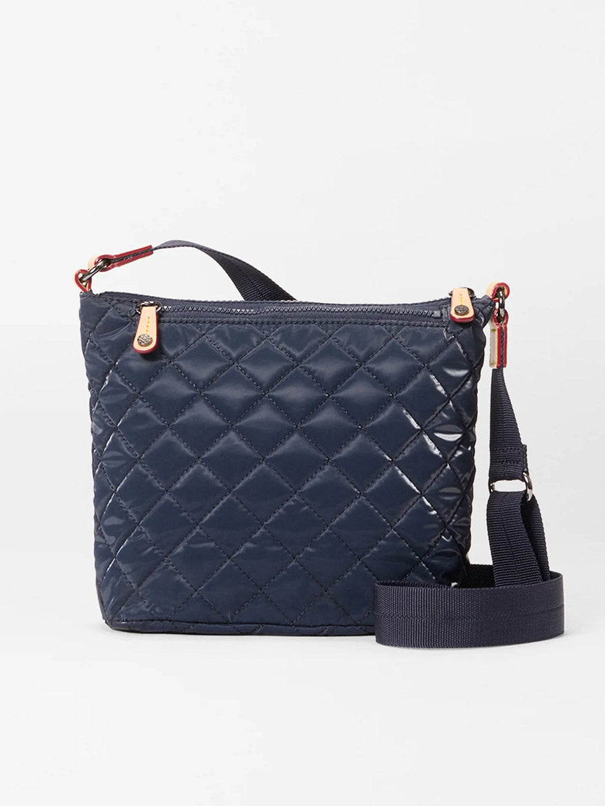 The MZ Wallace Metro Scout Deluxe in Ink Liquid Oxford is a quilted crossbody bag with gold hardware, a zip top, and an adjustable shoulder strap, shown against a plain white background.