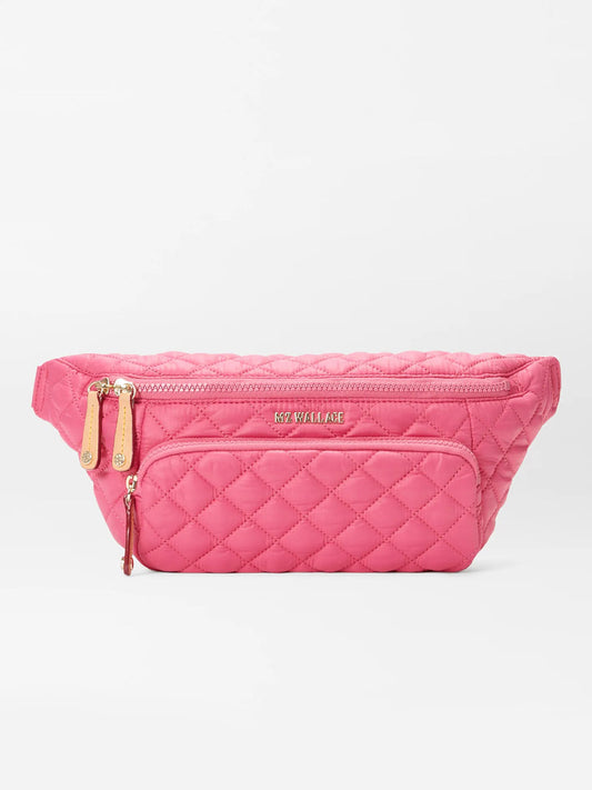 Bright pink quilted MZ Wallace Metro Sling in Zinnia Oxford with a gold zipper and logo detail, displayed against a white background.