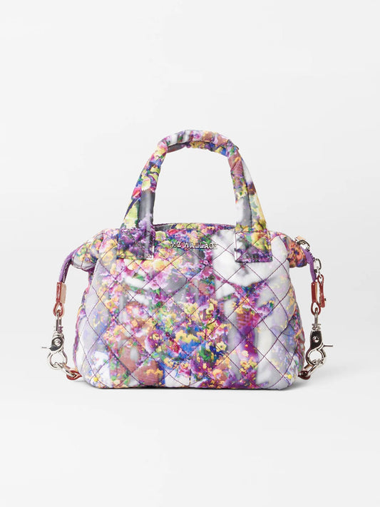 A MZ Wallace Micro Sutton in Cherry Blossom with floral patterns and silver hardware, featuring a crossbody strap, displayed against a white background.