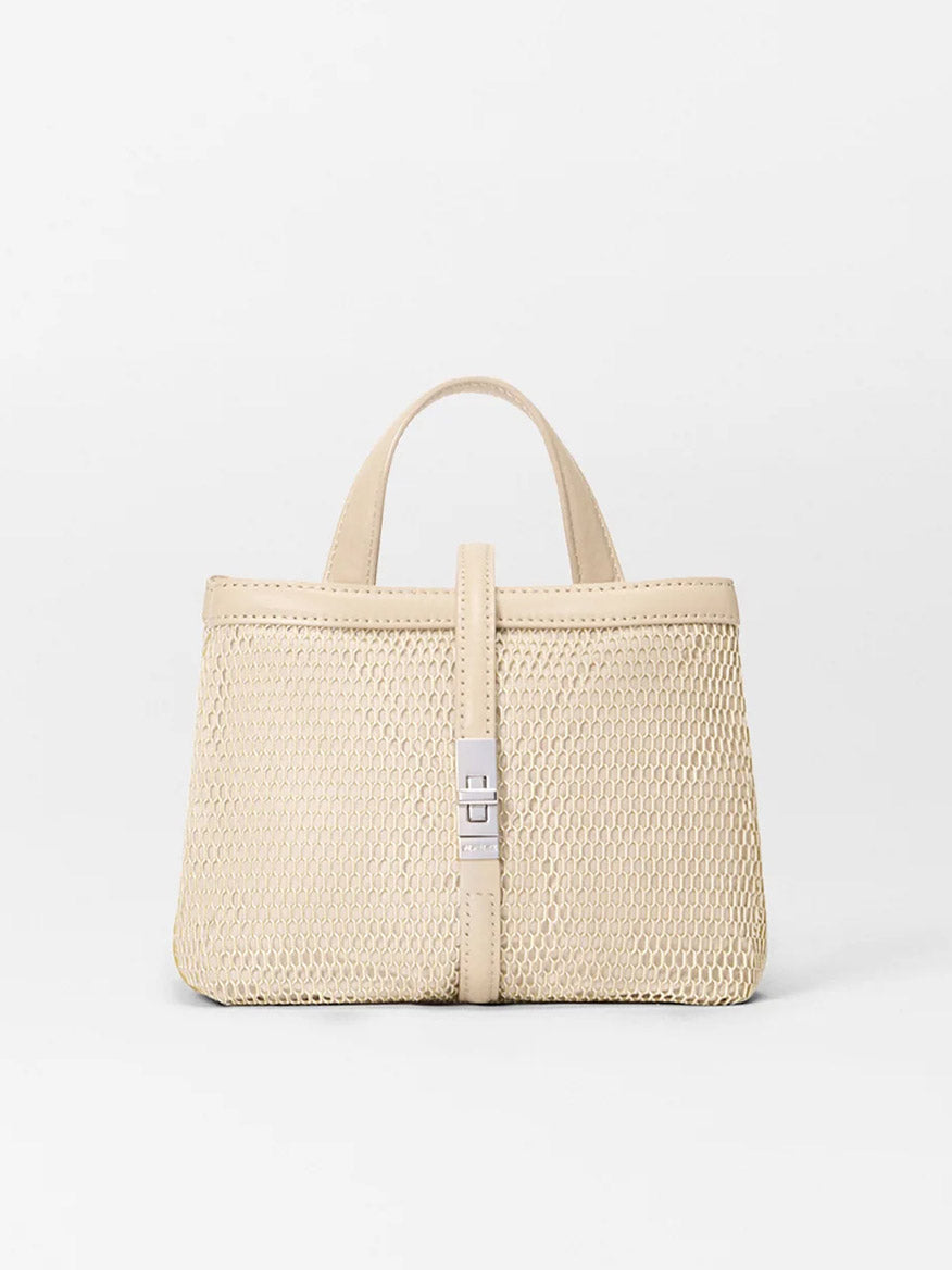 The MZ Wallace Mini Astor Top Handle in Buff Mesh features two short handles, an Italian leather strap, and a silver clasp. Styled against a plain white background, it’s an elegant piece from the Astor Collection.