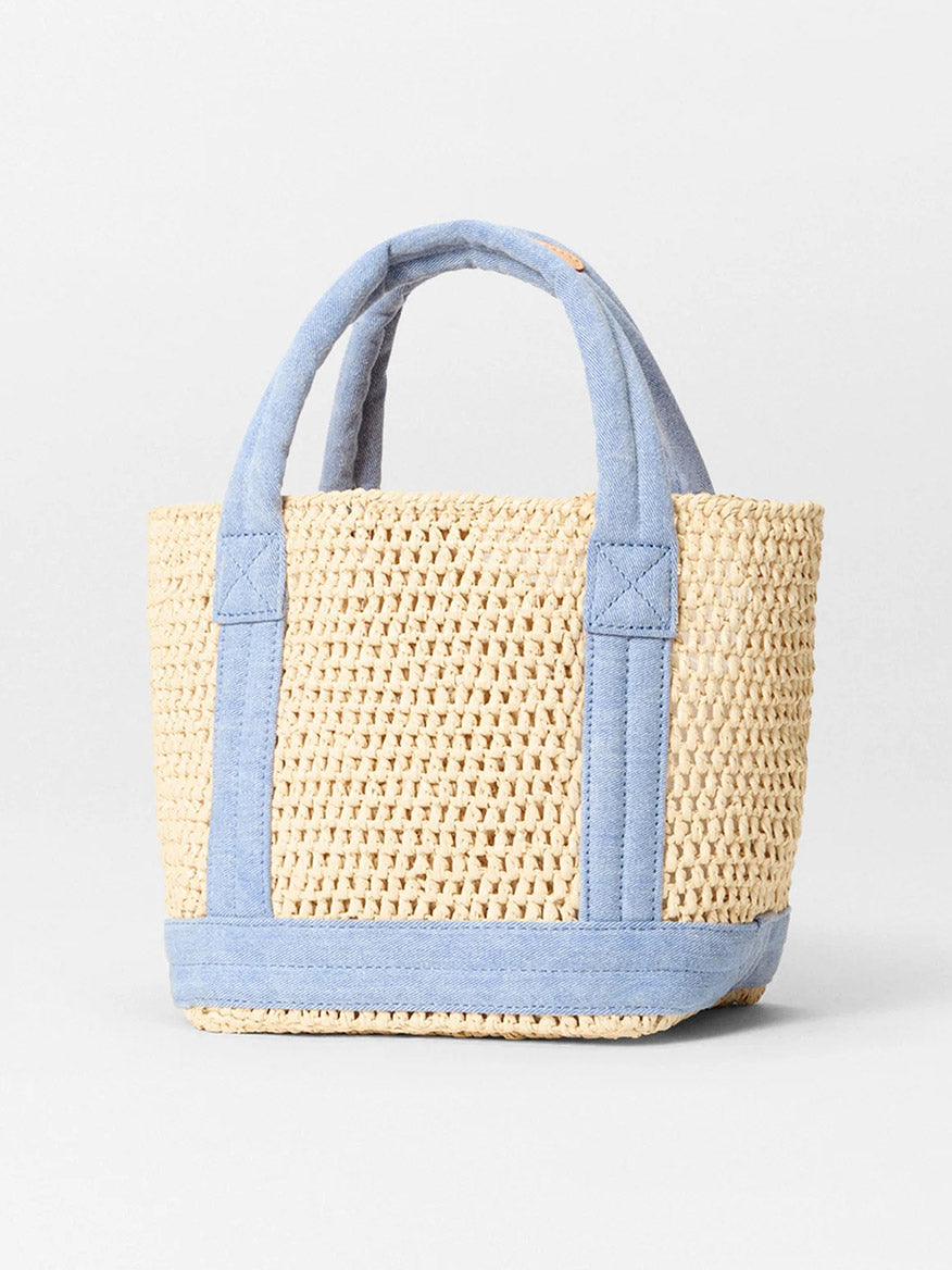 The MZ Wallace Mini Crochet Tote in Crochet/True Light Denim features a woven design with blue fabric handles and trim, accented by Italian leather, set against a plain white background.