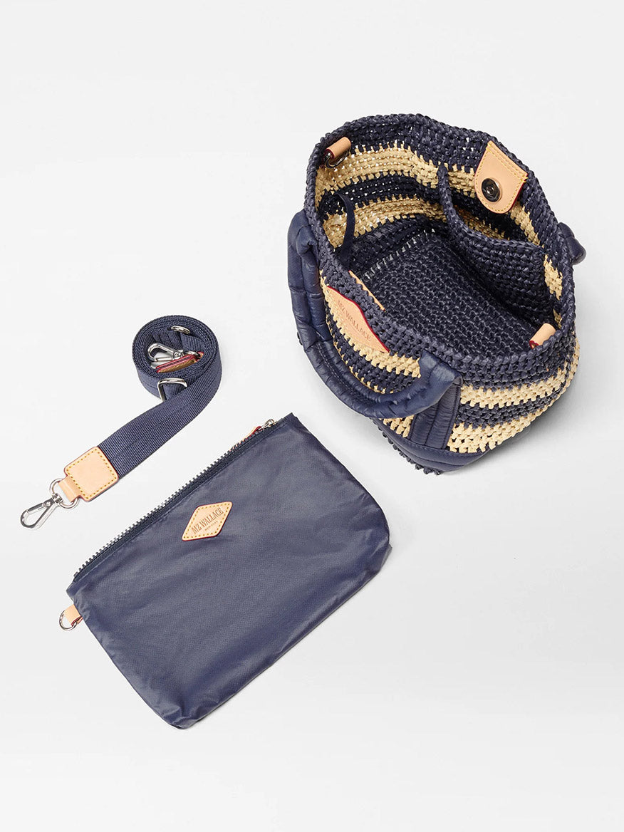 The MZ Wallace Mini Crochet Tote in Dawn/Natural Stripe Crochet is displayed open, featuring a matching detachable strap and a separate navy zippered pouch placed beside it.