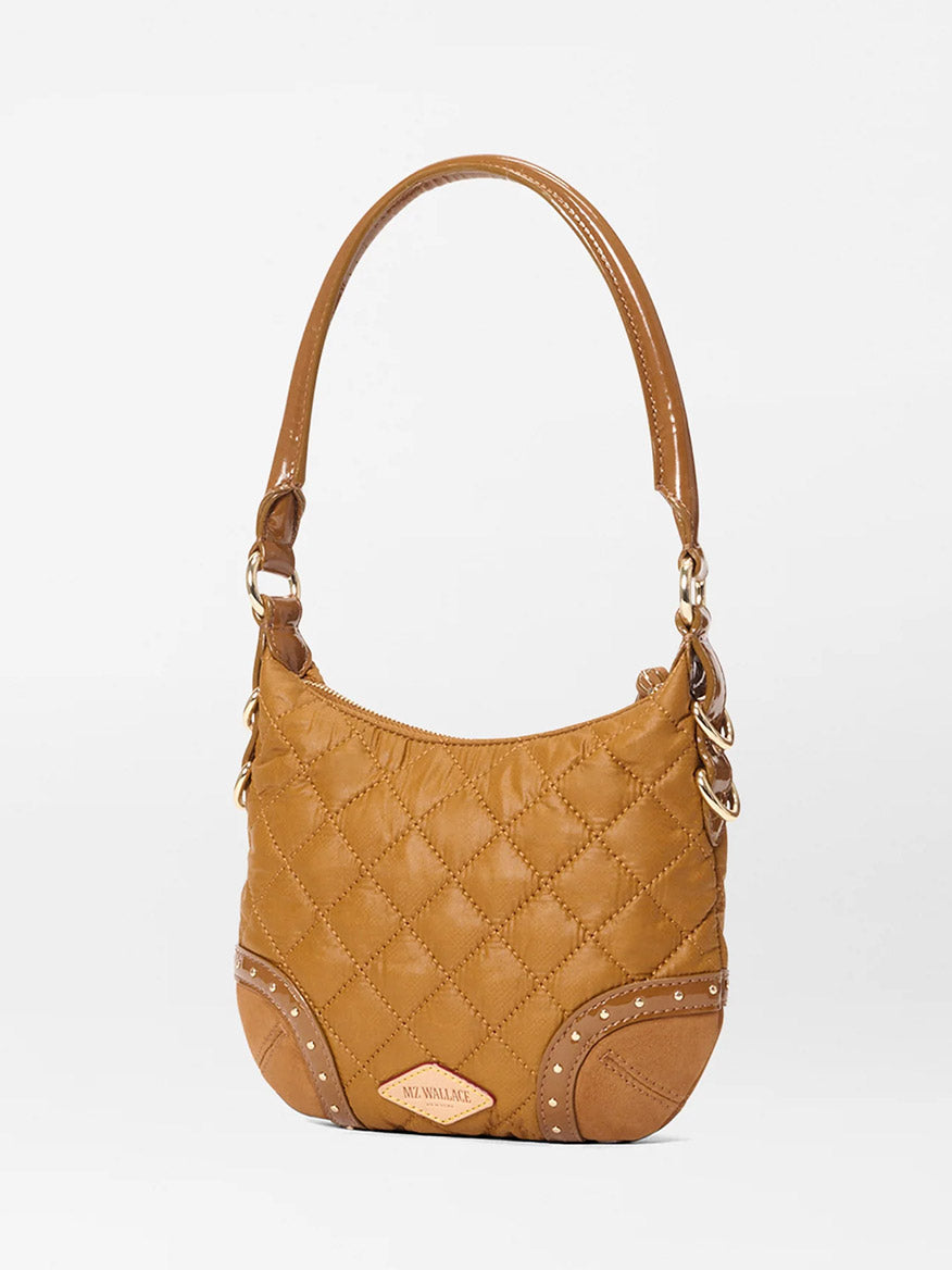 The MZ Wallace Mini Multi Stud Crosby Sienna in Amber Stud & Suede is a brown quilted handbag with Italian leather trim, single handle, gold-toned hardware, and decorative stitching, shown against a plain white background.