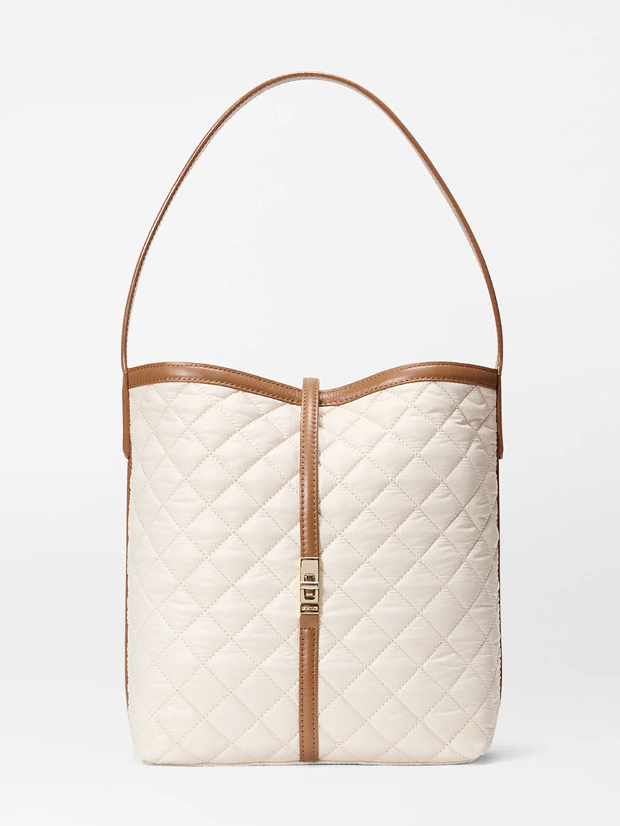 The MZ Wallace Small Astor Hobo in Sandshell Oxford with Brown is a cream-colored, quilted nylon shoulder bag featuring Italian leather trim, a single strap, and a gold-tone front clasp.