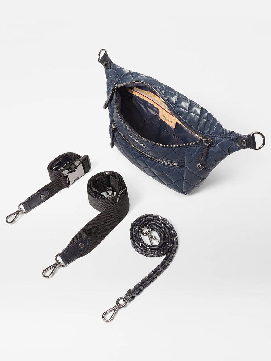 The MZ Wallace Small Crosby Sling Bag in Ink Liquid Oxford features a quilted design, an open zipper, and comes with three detachable straps: black webbing, black leather, and braided navy.
