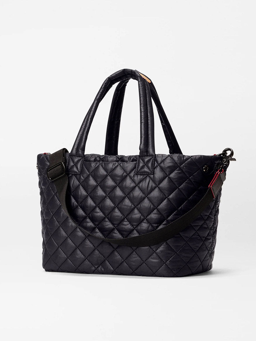 The MZ Wallace Small Metro City Tote in Black Oxford features a quilted exterior, two short handles, a detachable long shoulder strap, and is shown on a plain white background.