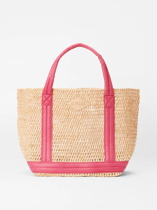 A MZ Wallace Small Raffia Tote in Raffia/Zinnia with bright pink padded nylon handles and trim, featuring a small logo that reads "liz wallace" on the front.