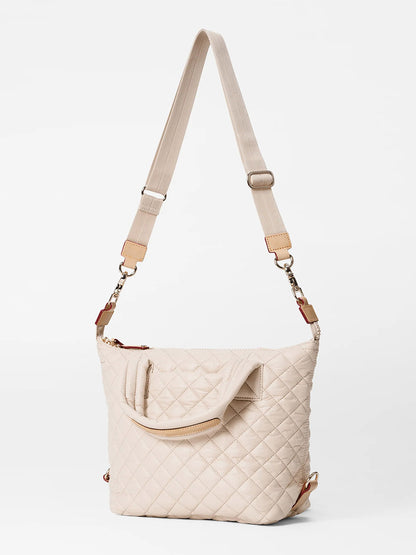 A small MZ Wallace Small Sutton Deluxe in Mushroom Oxford quilted shoulder bag with nylon handles and an adjustable crossbody strap displayed against a white background.