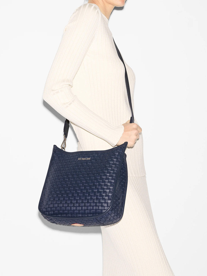 Woman in a white dress carrying a MZ Wallace Woven Box Crossbody in Dawn Oxford.
