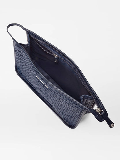 A blue textured MZ Wallace Woven Metro Clutch in Dawn Oxford open to show the interior and zipper compartment.