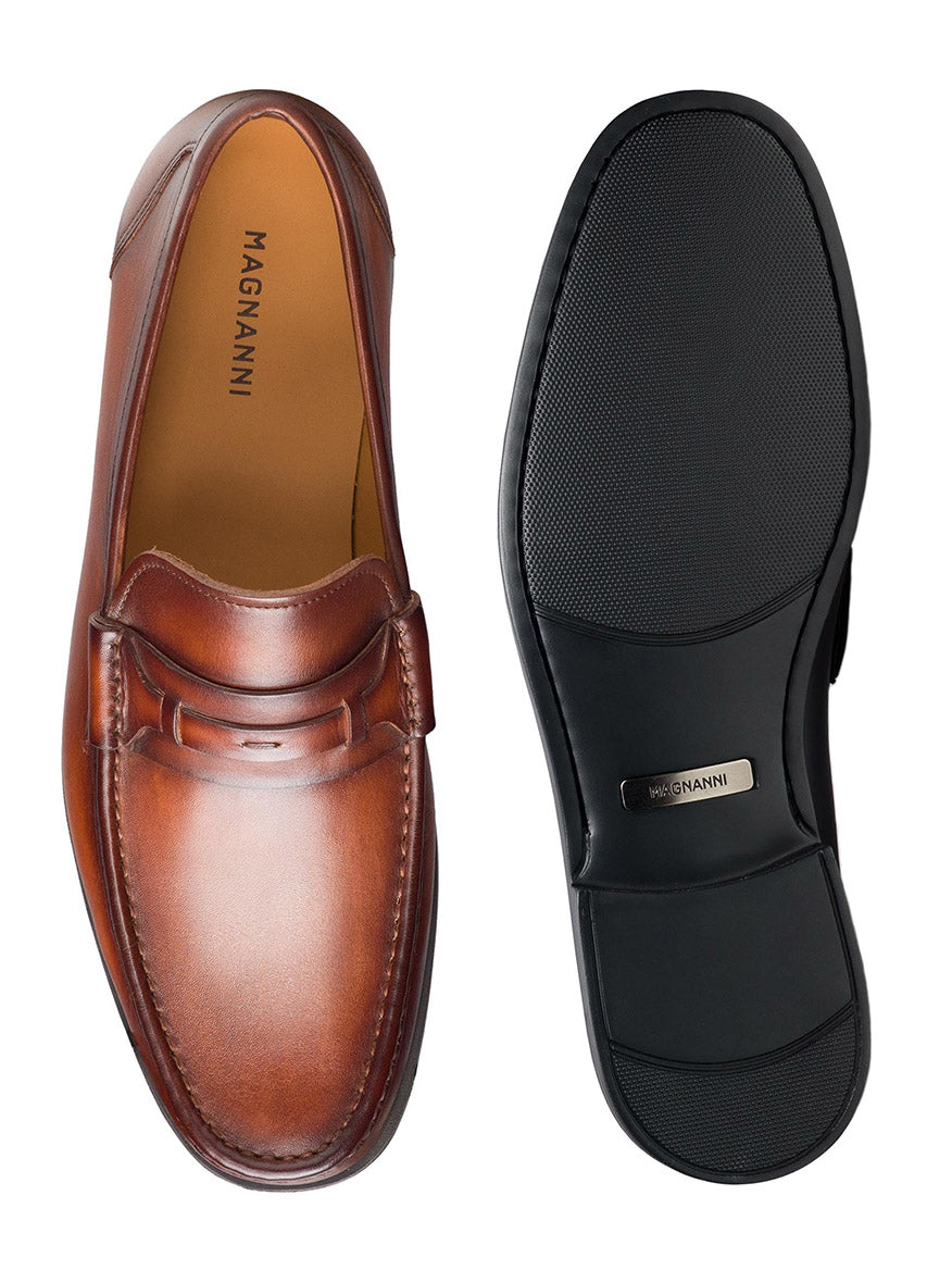 A pair of Magnanni Daren in Cognac, featuring a moccasin toe design, with one shoe showing the top view and the other displaying the cushioned rubber sole.
