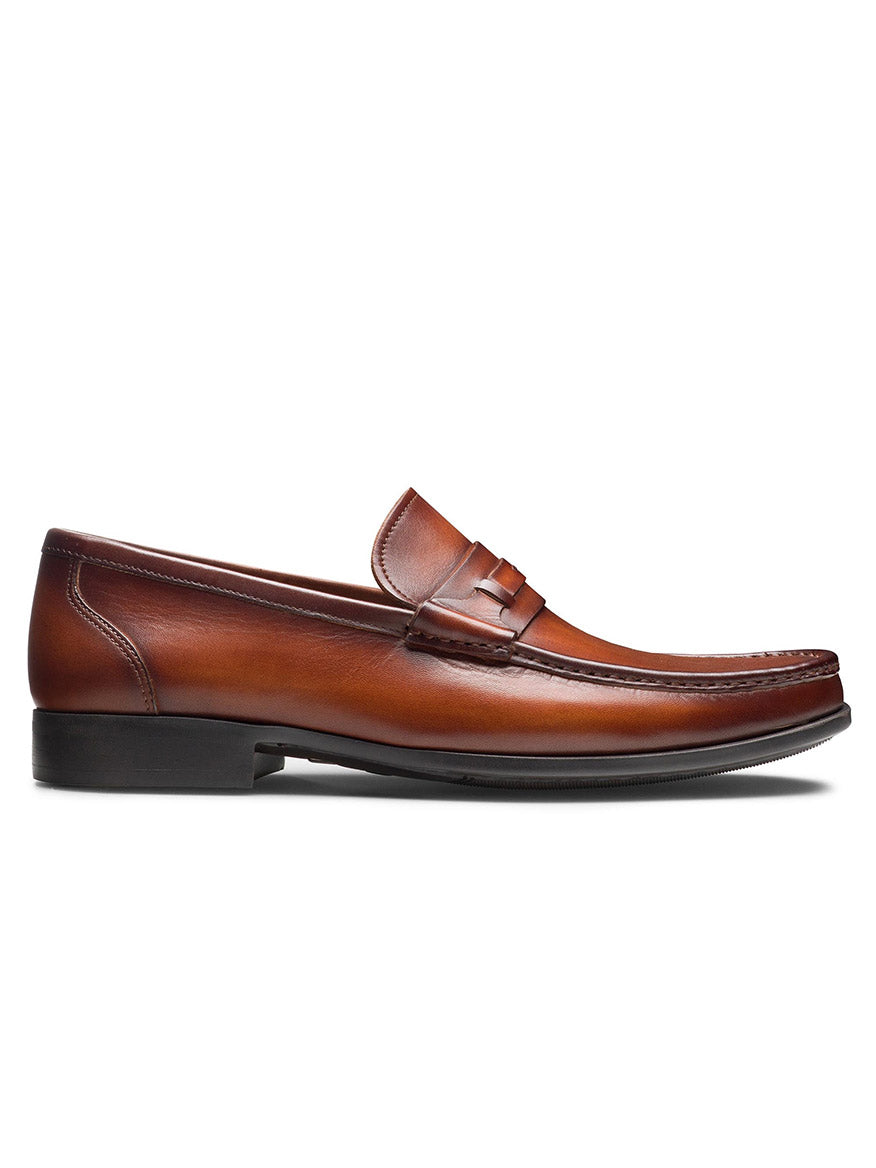 A Magnanni Daren in Cognac with a penny strap, dark stitching, and a cushioned rubber sole showcased from the side view.