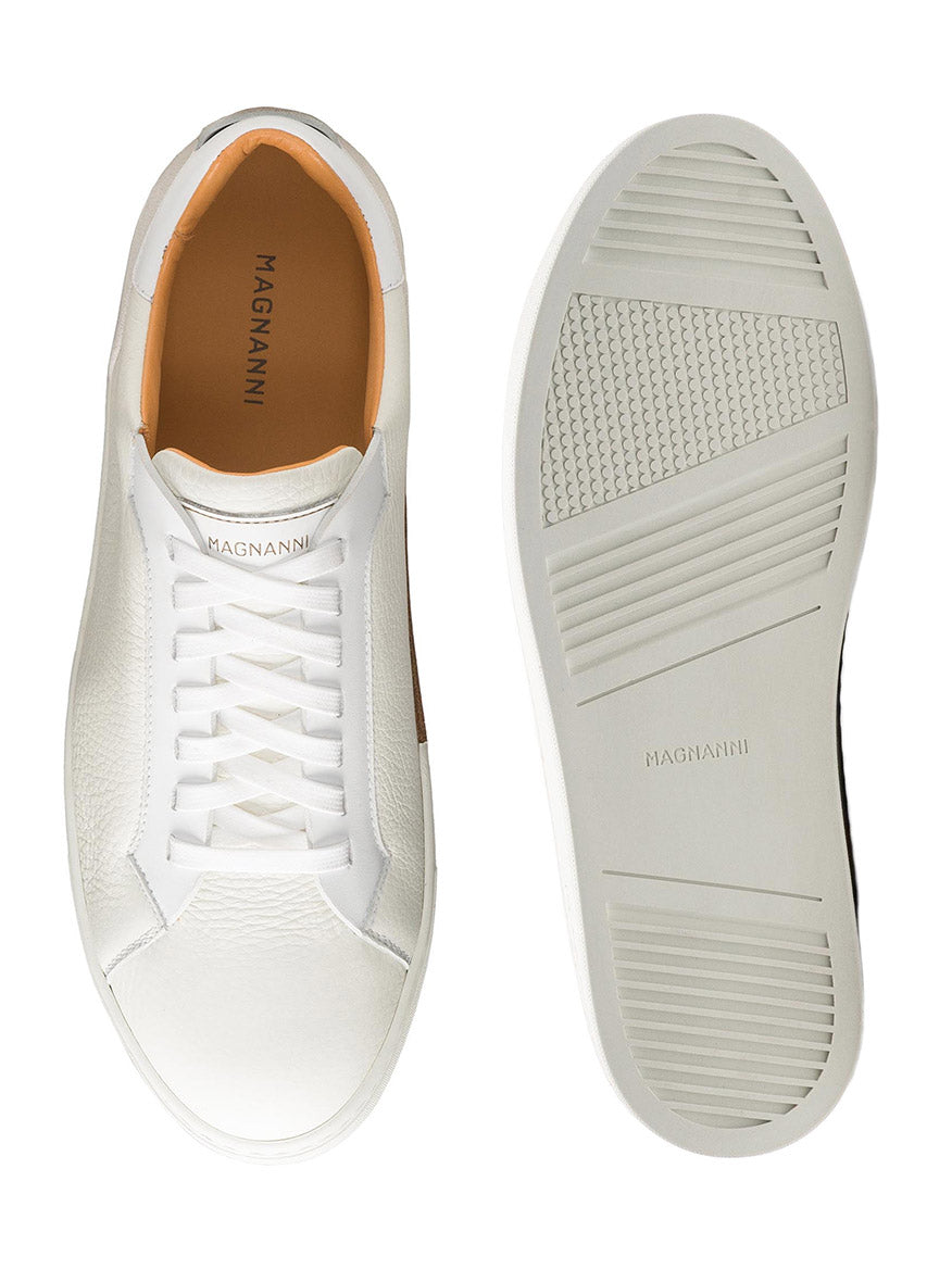 Experience the luxury of Magnanni Amadeo in White, contemporary sneakers made in Spain with textured sides and leather lining. They feature branding on the insole and sole, with a ridged outsole for grip.