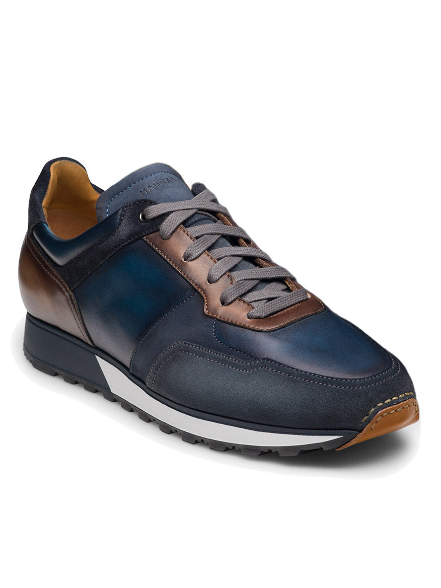 Magnanni Arco in Navy/Brown: A blue and brown leather sneaker with gray laces, white midsole, textured outsole, and classic runner sole.