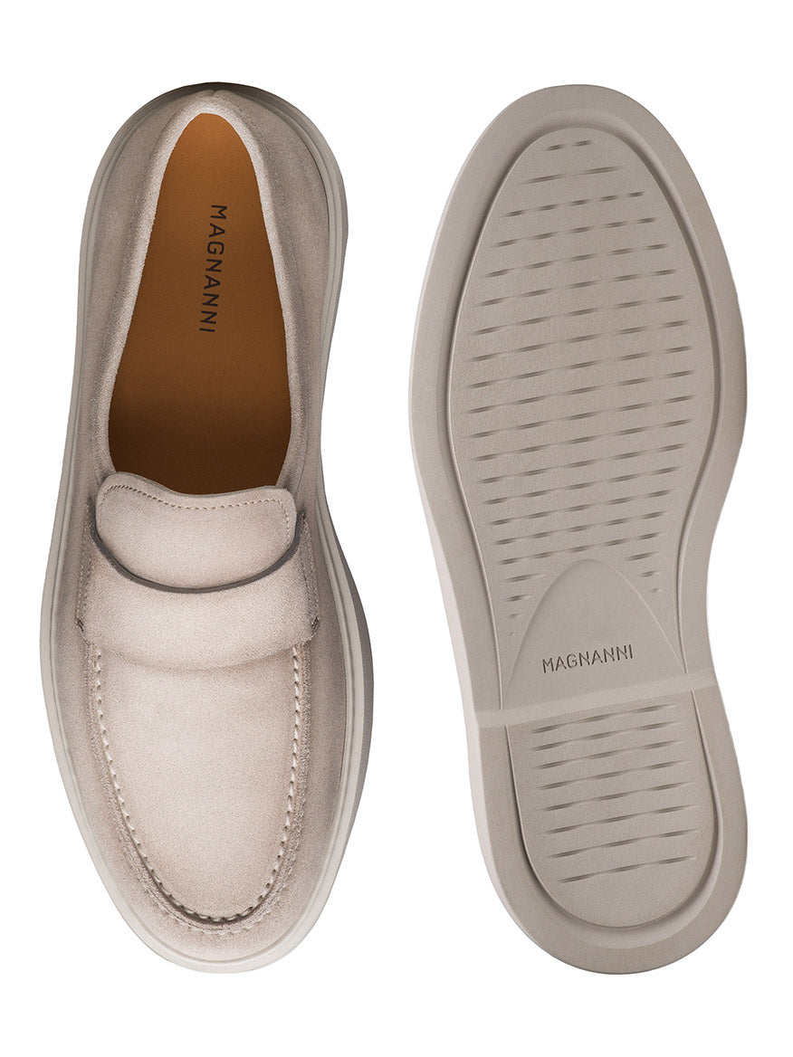 A pair of Magnanni Bandera slip-on loafers in Bone Suede showcase both top and sole views, crafted with premium supple materials for a timeless elegant touch.