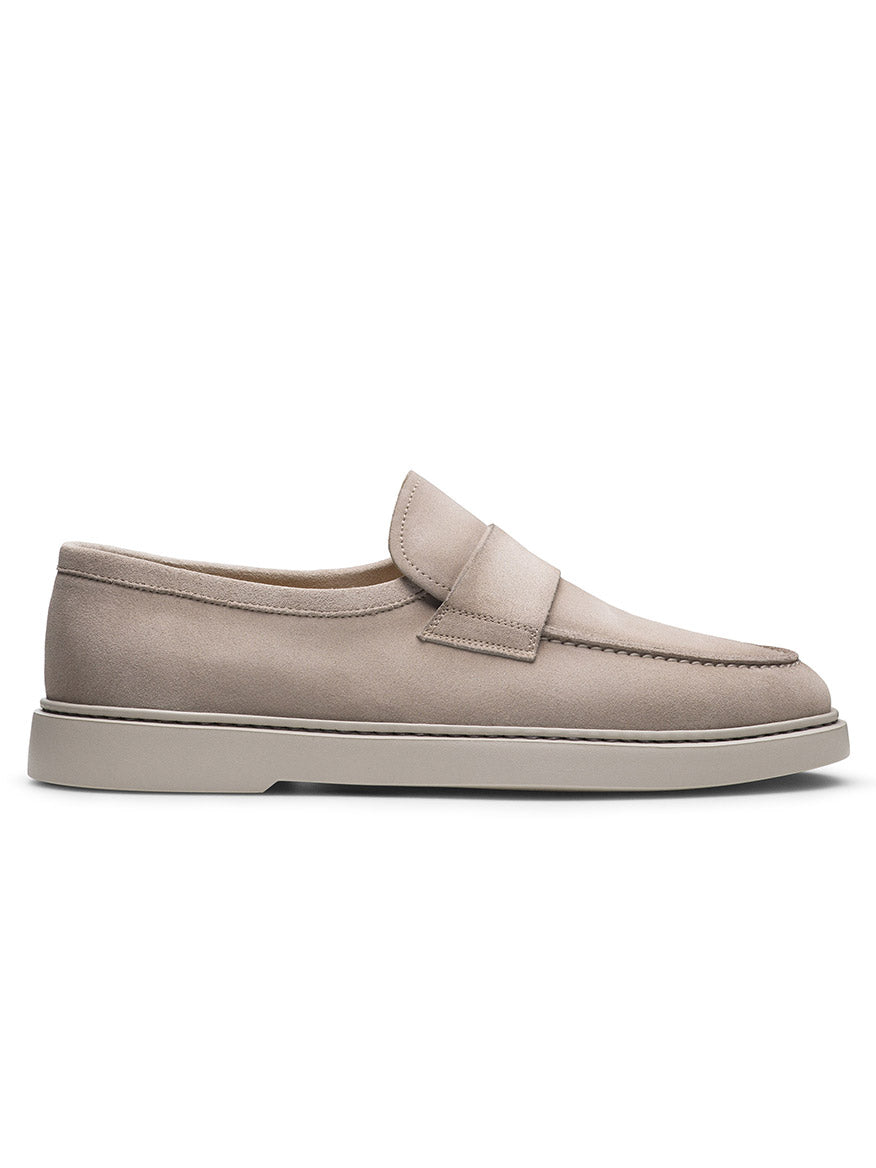 The Magnanni Bandera in Bone Suede is a slip-on loafer crafted from premium suede, featuring a low heel and subtle seam detail, embodying timeless elegance.